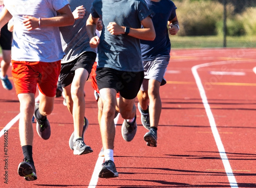 Group of boys run training on a track