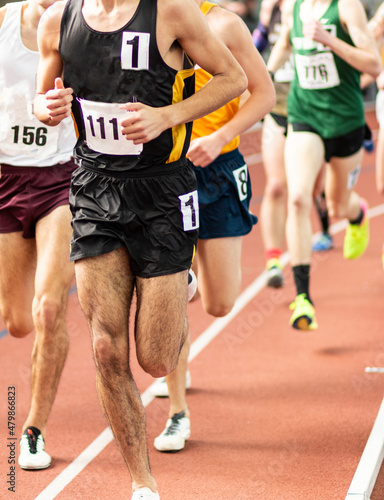 Runners running an indoor mile race