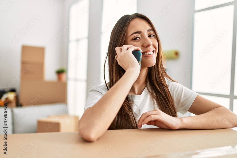 Young hispanic woman smiling confident talking on the smartphone at new home Young hispanic woman smiling confident talking on the smartphone at new home