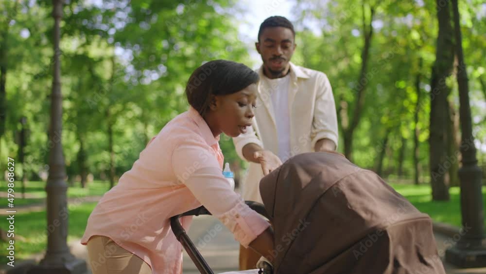 African American couple having argument about parenting while walking in park African American couple having argument about parenting while walking in park