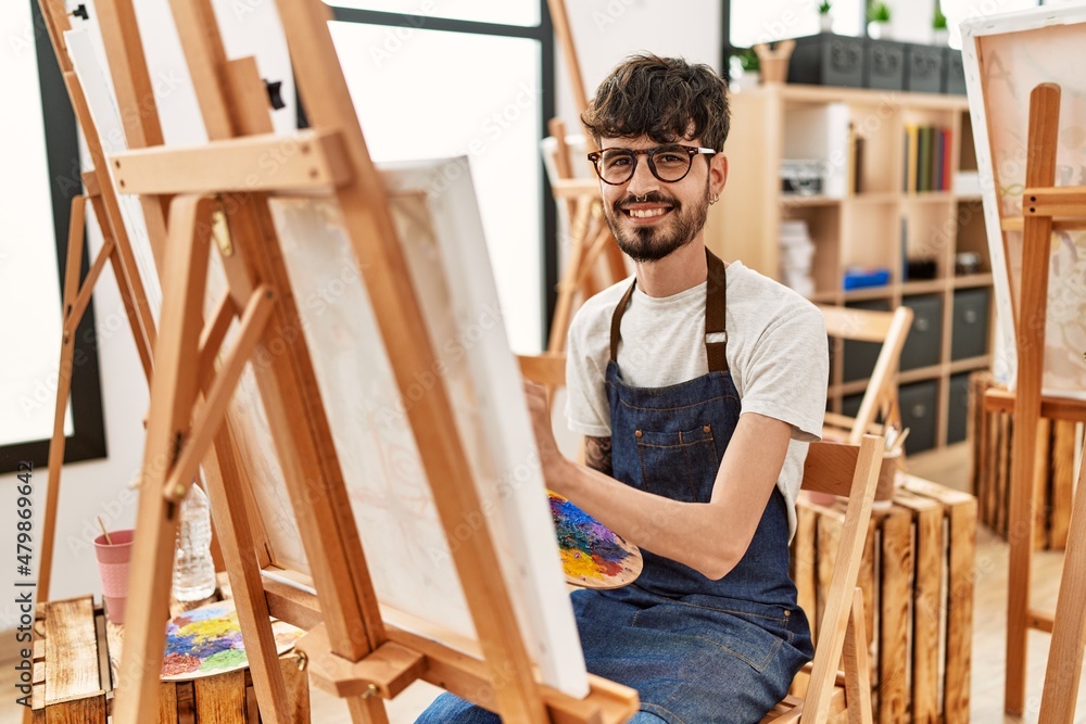 Young hispanic artist man smiling happy drawing at art studio. Young hispanic artist man smiling happy drawing at art studio.