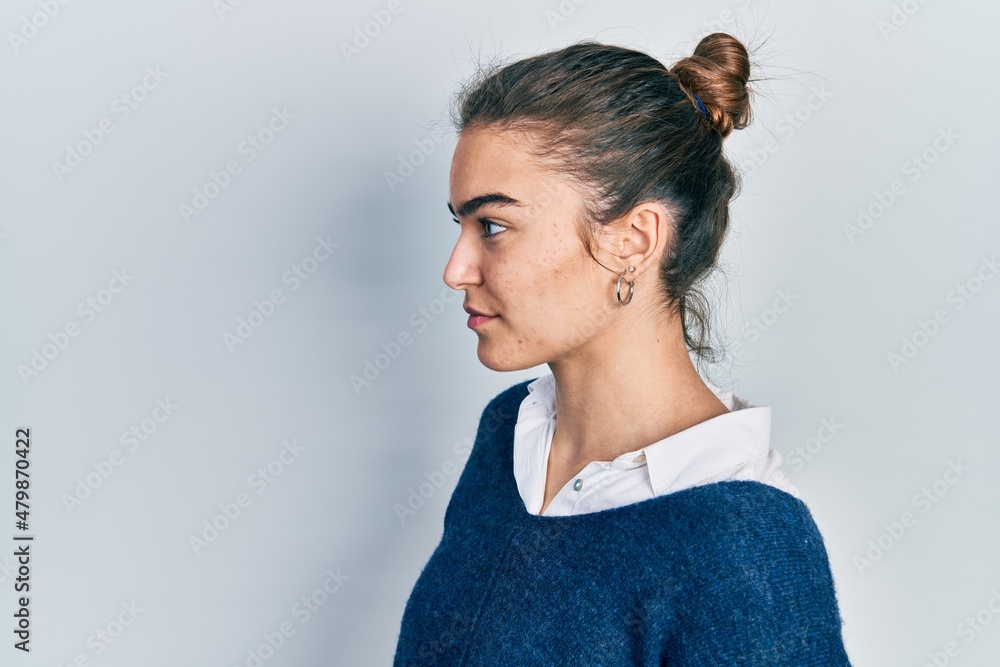 Fototapeta premium Young caucasian girl wearing casual clothes looking to side, relax profile pose with natural face with confident smile.
