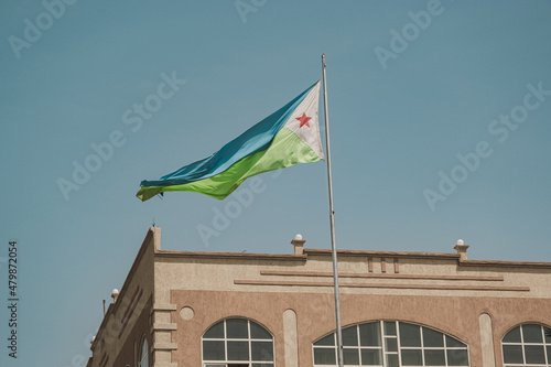 Djibouti flag waving in Djibouti. Editorial shot in Djibouti. photo