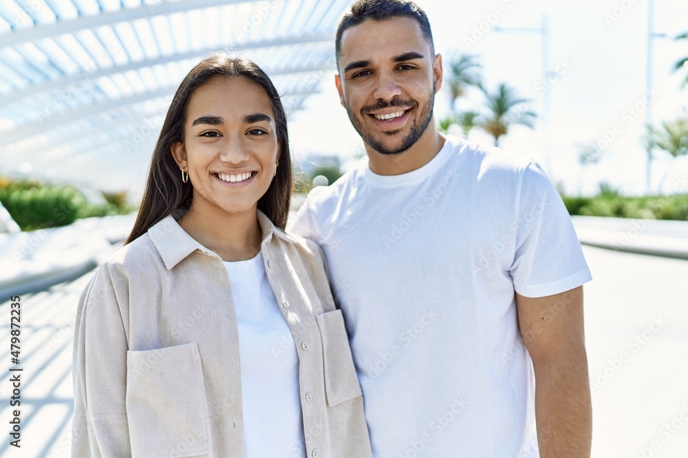 Young latin couple smiling happy and hugging at the city. Young latin couple smiling happy and hugging at the city.