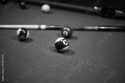 Billiard table in the billiard room with balls and cue