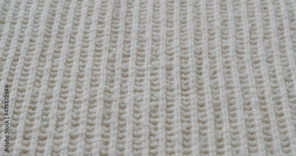 Beige woolen fabric close-up. Macro shooting of soft and warm knitted cloth. Woolen clothing, abstract background. Tailoring and sewing concept. Material sample. Beige woolen fabric close-up. Macro shooting of soft and warm knitted cloth. Woolen clothing, abstract background. Tailoring and sewing concept. Material sample.