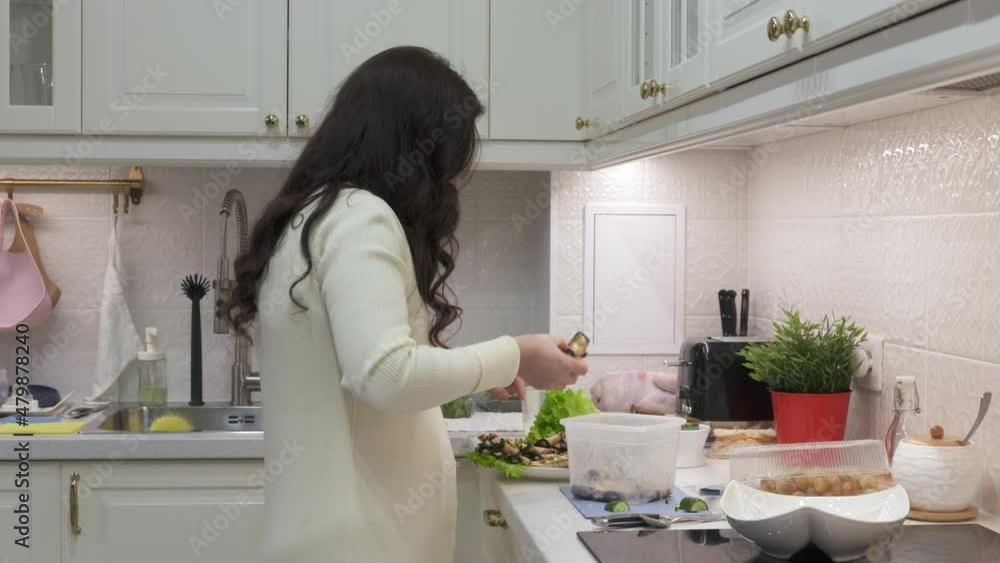 Woman cooking festive dinner in the kitchen making toast with cucumber and caviar. Bread topped with cream cheese, cucumber and salmon roe. High quality 4k footage Woman cooking festive dinner in the kitchen making toast with cucumber and caviar. Bread topped with cream cheese, cucumber and salmon roe. High quality 4k footage