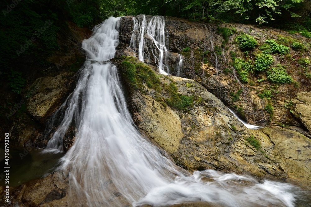 Naklejka premium trekking around waterfall in summer
