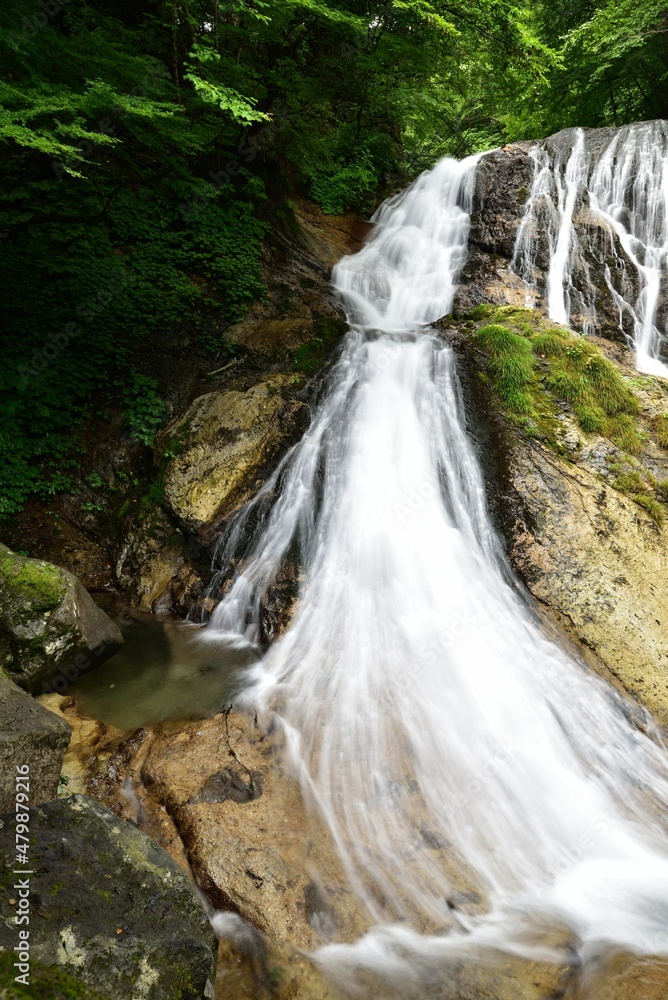 Obraz premium trekking around waterfall in summer