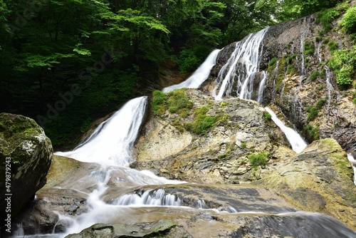 trekking around waterfall in summer photo