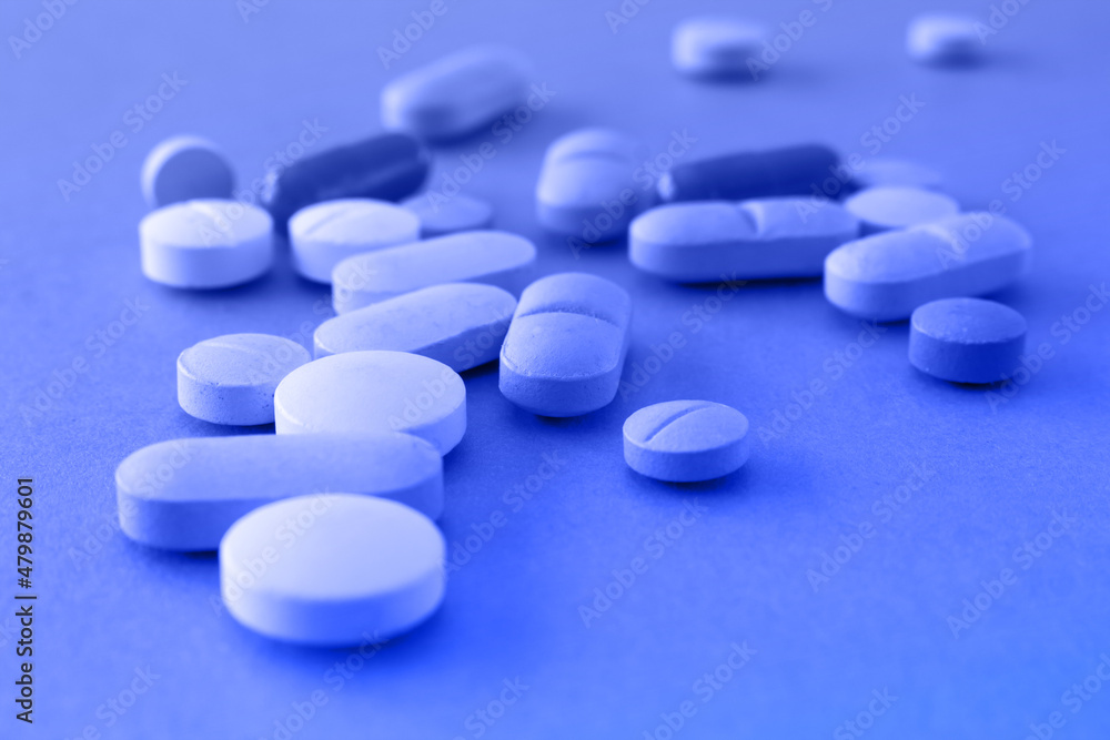 Blue and light blue pills. Concept of male erectile difficulty or medical environment. Blue and light blue pills. Concept of male erectile difficulty or medical environment.