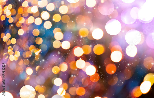 Bokeh circle lights at night in party. Background for celebrating Christmas, Happy New Year, and Anniversary.