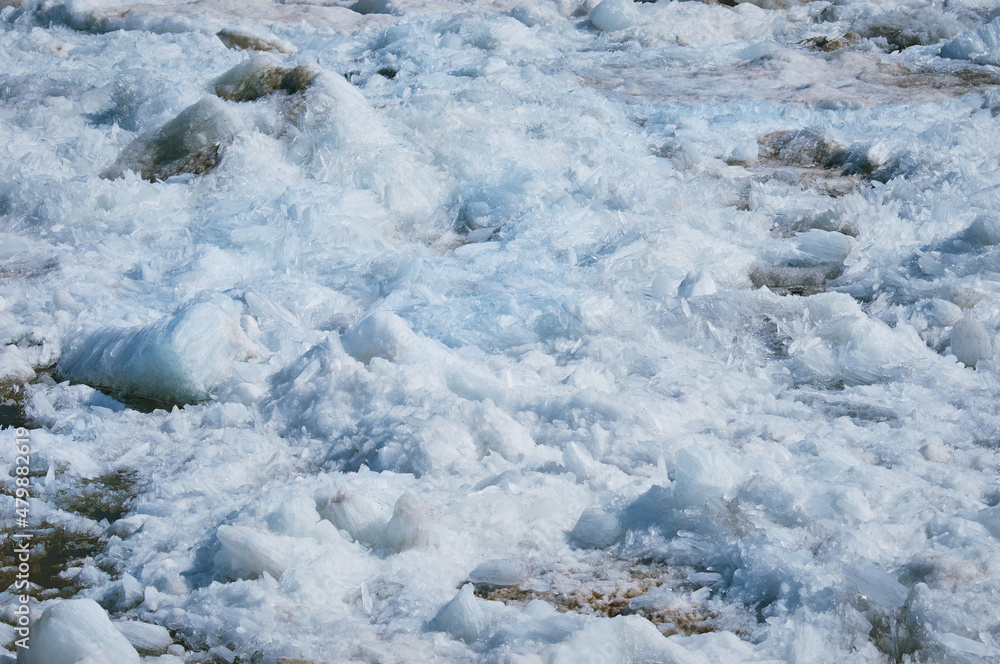 Melting ice on the river in spring. Ice drift time. Natural structure.