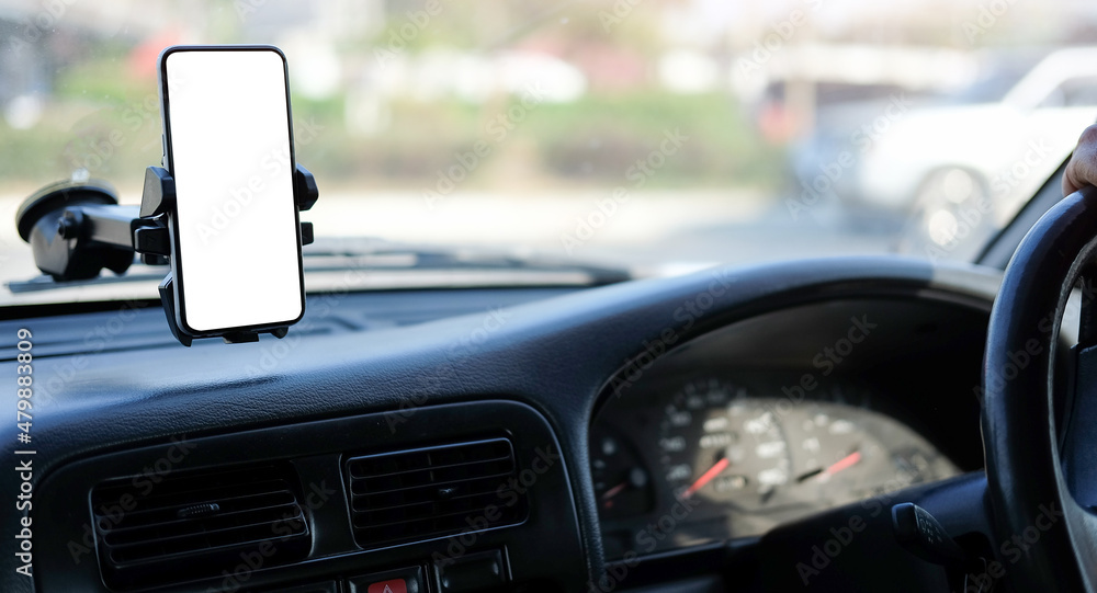 Mockup smartphone on universal mount holder in car. Blank screen for your advertising text.