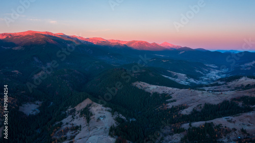 Aerial view of mountain range under sunlight