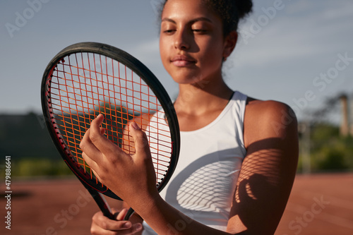 Black sportswoman with racket on tennis court © kegfire