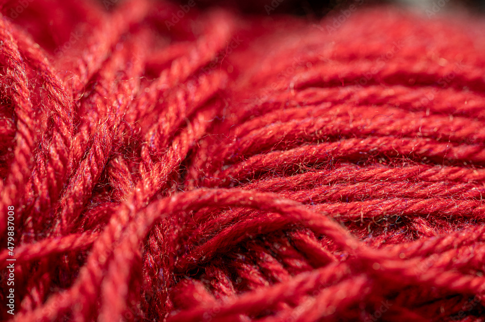 Red yarn macro view. Abstract of cotton blend yard up close, with fibers going in multiple directions. Material ready for use in hand crafts background concept. Red yarn macro view. Abstract of cotton blend yard up close, with fibers going in multiple directions. Material ready for use in hand crafts background concept.
