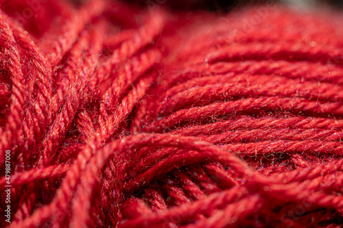 Red yarn macro view.  Abstract of cotton blend yard up close, with fibers going in multiple directions.  Material ready for use in hand crafts background concept.