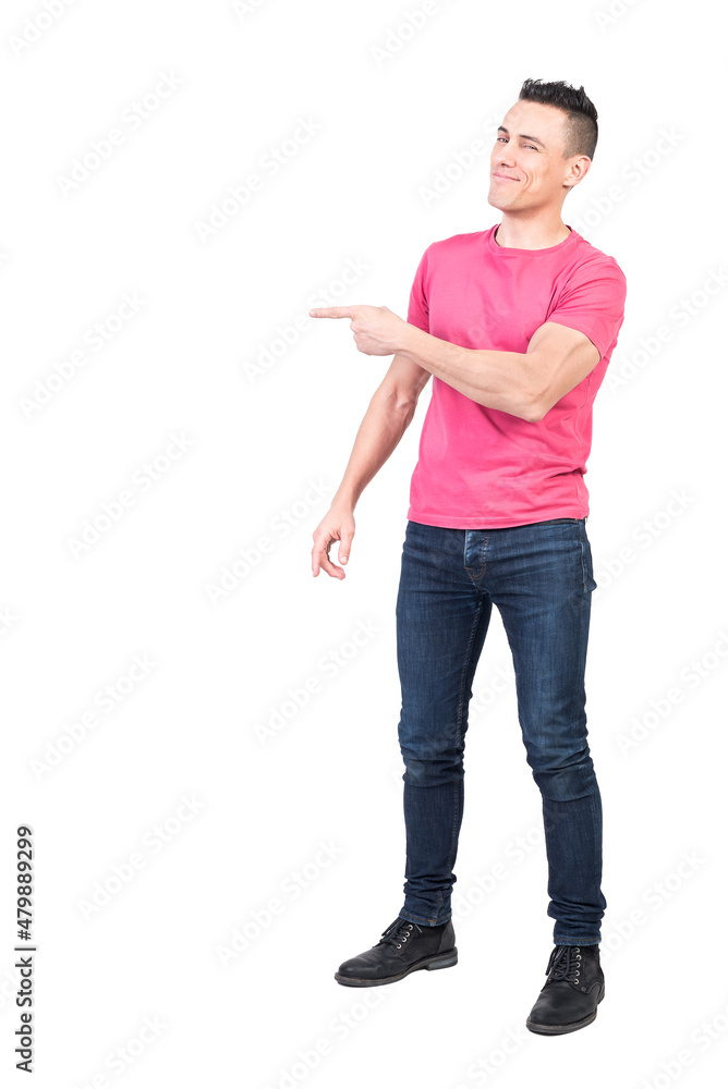 Cheerful man pointing aside in studio. White background