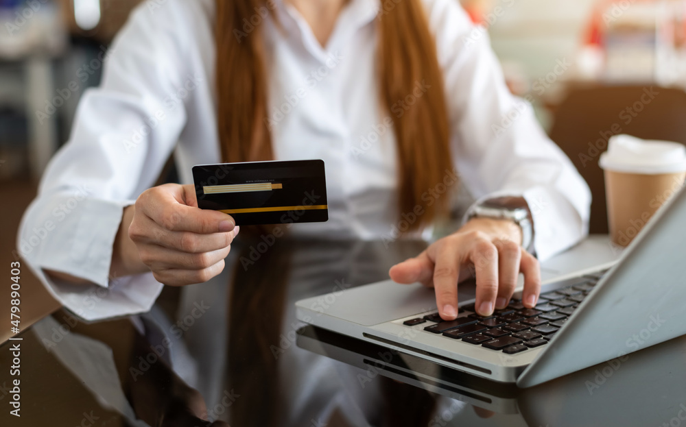businesswoman hand using smart phone, tablet payments and holding credit card online shopping, omni channel, digital tablet docking keyboard computer businesswoman hand using smart phone, tablet payments and holding credit card online shopping, omni channel, digital tablet docking keyboard computer