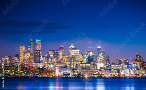 seattle city skyline at night with reflection in water. seattle washington usa.
