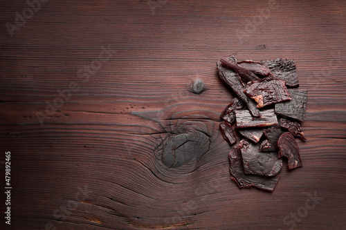 Meat jerky product on wooden textured background