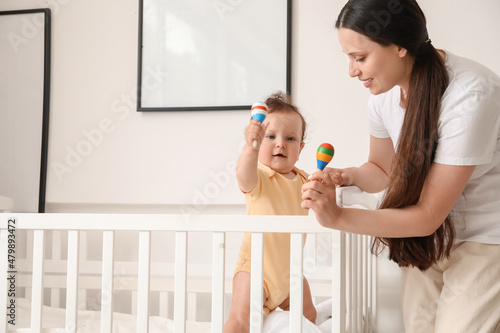 Young mother giving toys to...