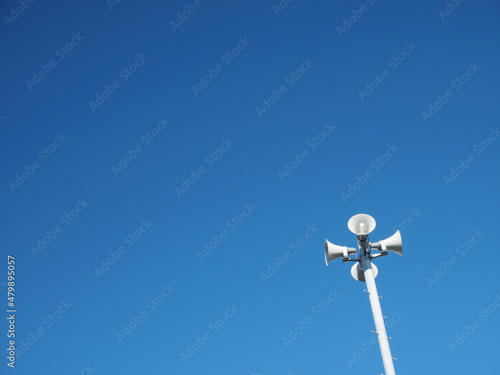 Loudspeakers with blue sky background.
