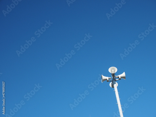 Loudspeakers with blue sky background.