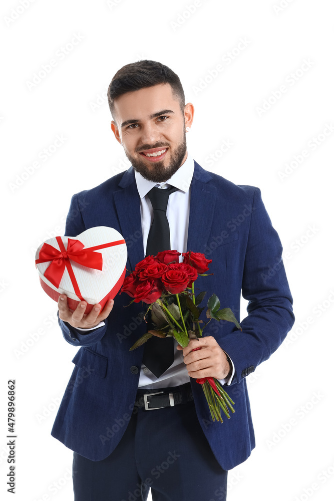 Handsome young man with gift and flowers for his girlfriend on white background. Valentine's Day celebration Handsome young man with gift and flowers for his girlfriend on white background. Valentine's Day celebration