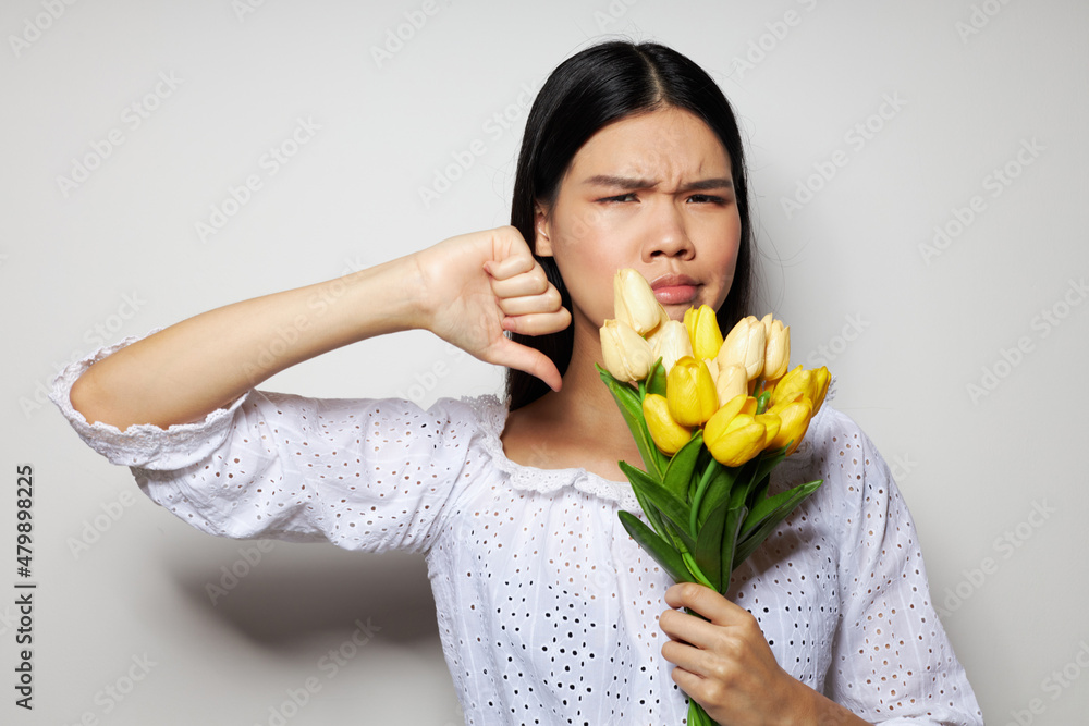 Portrait Asian beautiful young woman in a white shirt flowers spring posing studio model unaltered Portrait Asian beautiful young woman in a white shirt flowers spring posing studio model unaltered