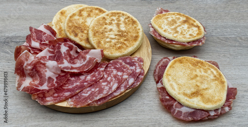 Delicious Italian Tigelle on wooden background. Traditional dish from Emilia-Romagna region. Bologna, Italy photo
