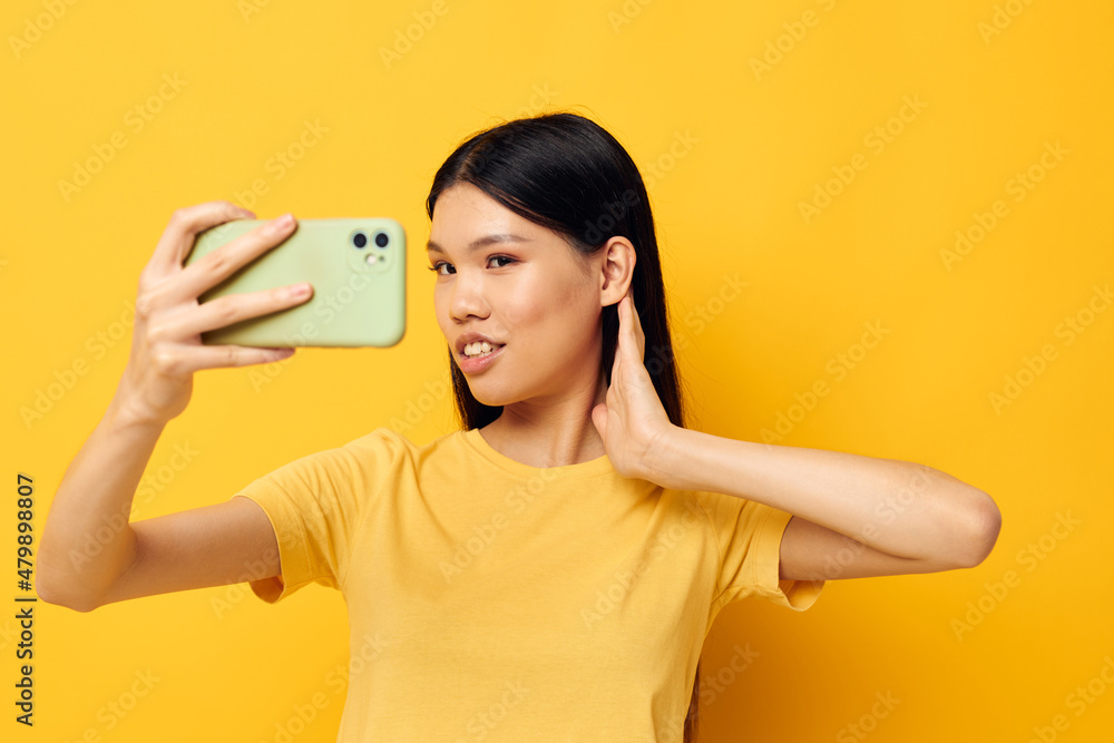 pretty brunette with a smartphone in hands fun emotions close-up Lifestyle unaltered pretty brunette with a smartphone in hands fun emotions close-up Lifestyle unaltered