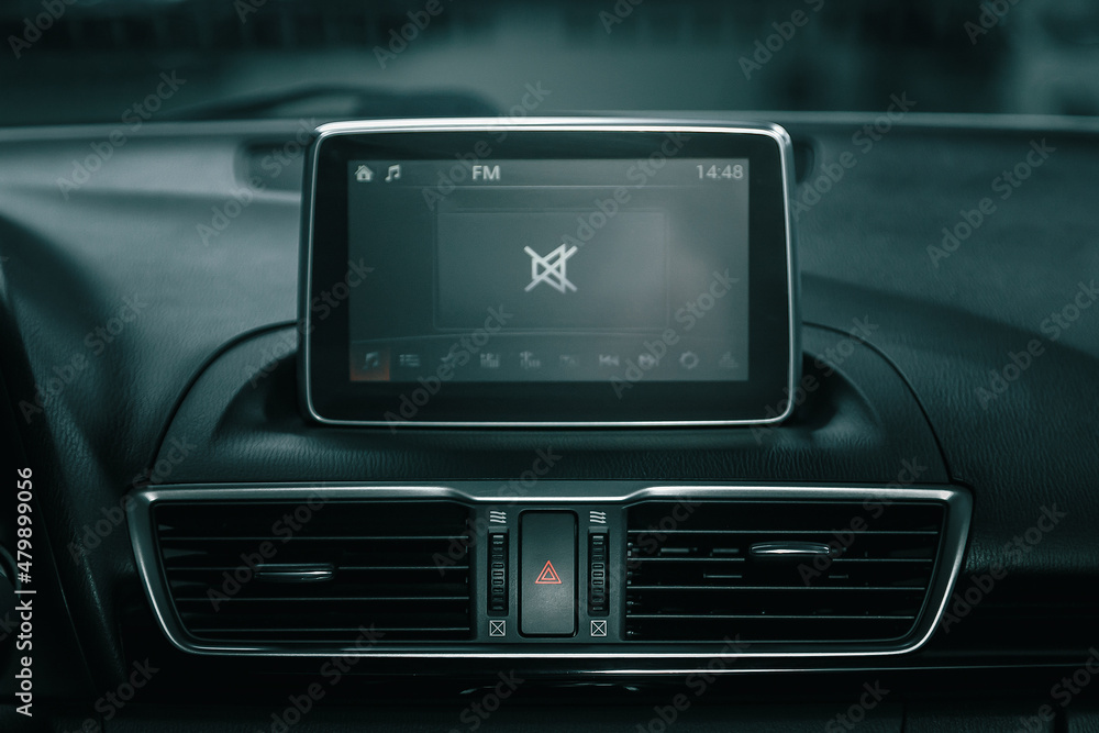 Car control panel of audio player and other devices.A shallow depth of field close up of the control panel of a car..