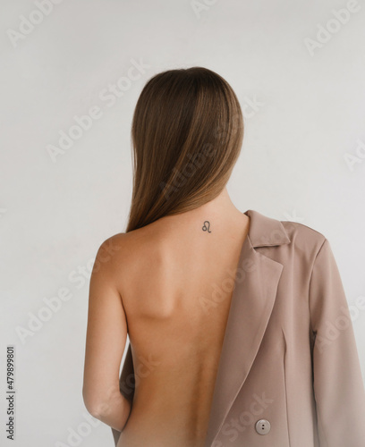 Pretty gentle Caucasian woman happy in bodysuit, business jacket. Daring fashion style portrait of decisive strong female in minimalistic room. sensual attractive girl with clean skin, decisive look