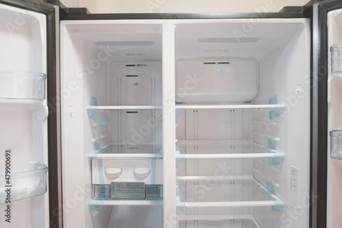 Opened new empty white refrigerator