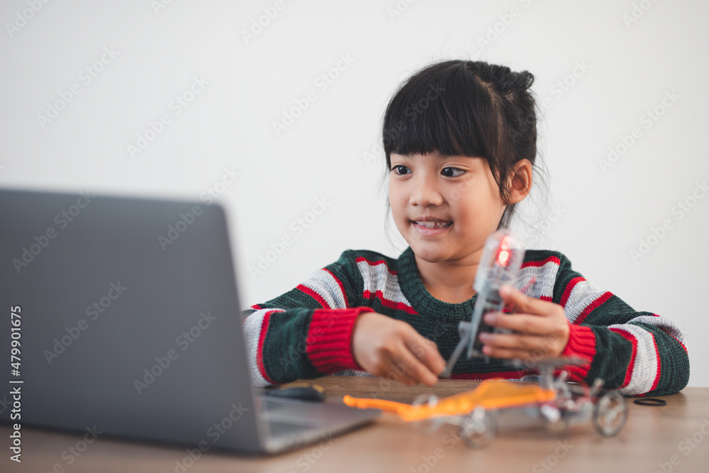 Inventive kid constructing robot cars at home