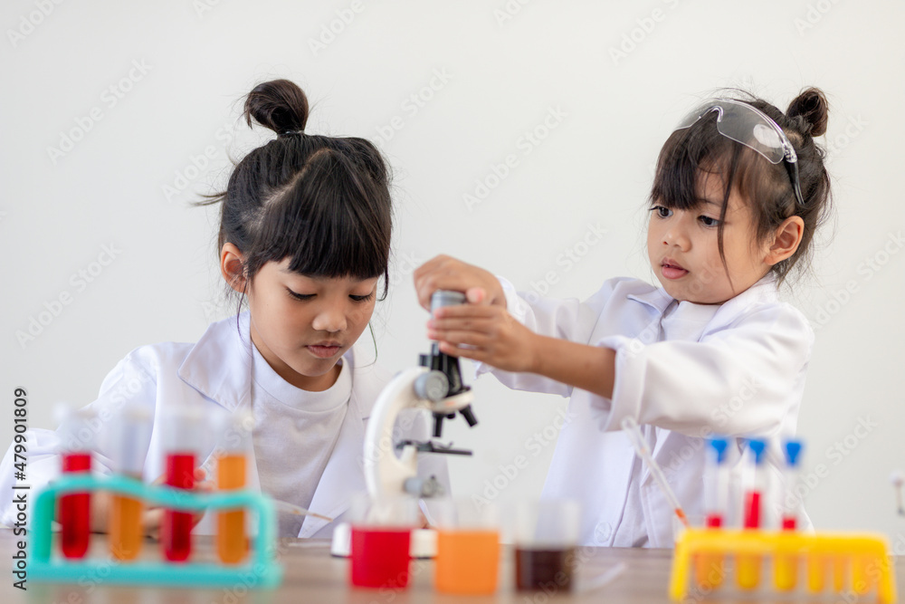 education, science, chemistry and children concept - kids or students with test tube making experiment at school laboratory education, science, chemistry and children concept - kids or students with test tube making experiment at school laboratory