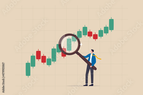 Stock market graph analysis, crypto trader trend line or finding buy and sell indicator, investment, forex trade or make profit concept, businessman investor holding magnifier analyze investment graph