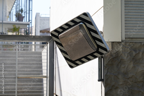 mirror hanging in street convex safety in the road cross access parking car