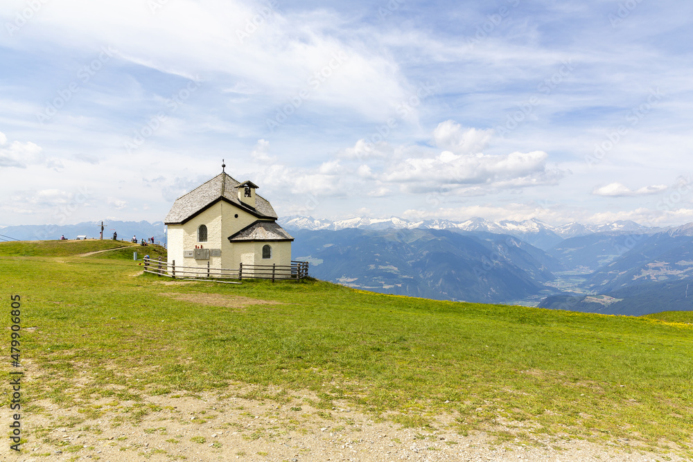 A beautiful view of Kronplatz (Plan de Corones) with mountain range in background A beautiful view of Kronplatz (Plan de Corones) with mountain range in background