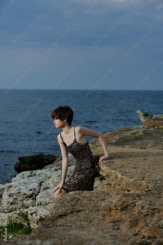 woman in dress in dress on nature rocks landscape outdoors