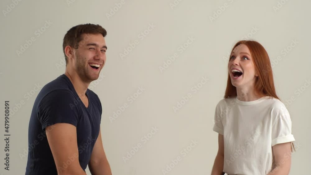 Studio portrait of happy cheerful young couple talking and laughing isolated on white isolated background. Joyful young man and woman having pleasant conversation. People lifestyle concept. Studio portrait of happy cheerful young couple talking and laughing isolated on white isolated background. Joyful young man and woman having pleasant conversation. People lifestyle concept.