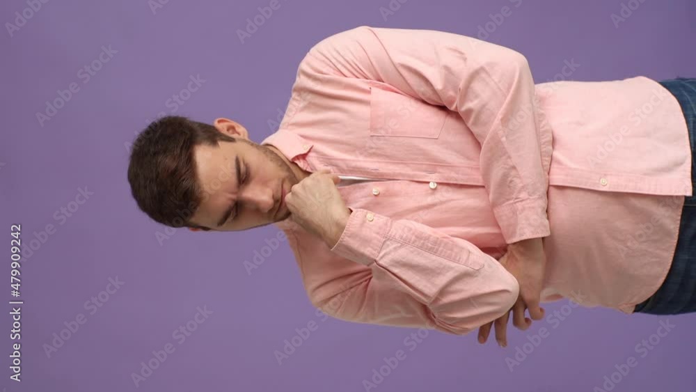 Vertical studio portrait of excited young man thoughtful about something and having idea moment pointing finger up on pink isolated background. Cheerful male showing eureka gesture, slow motion. Vertical studio portrait of excited young man thoughtful about something and having idea moment pointing finger up on pink isolated background. Cheerful male showing eureka gesture, slow motion.