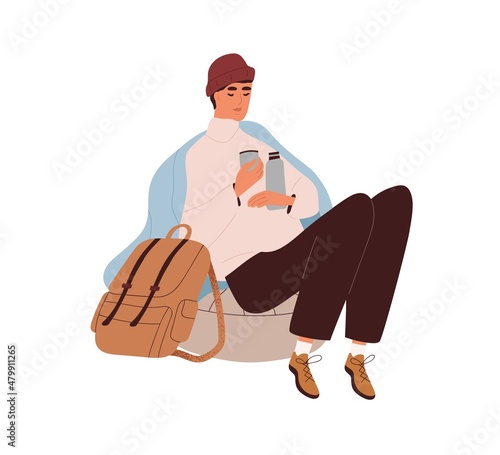 Tourist resting and warming with hot drink from thermos. Hiker with backpack ...