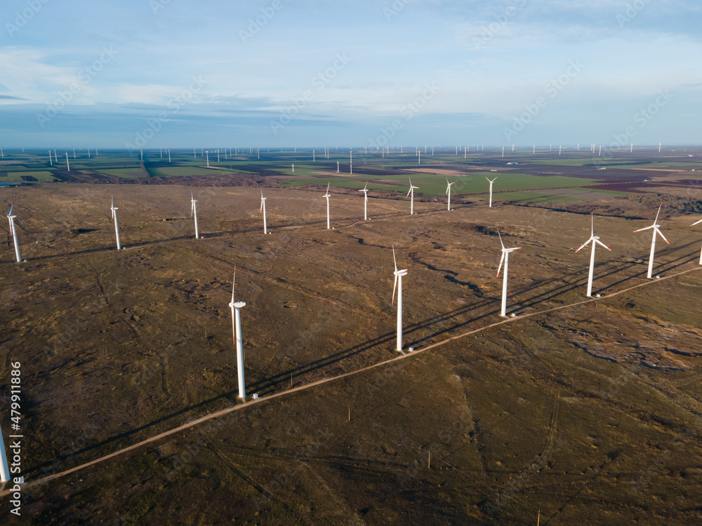 Fototapeta premium Aerial view of wind turbine farm producing green energy