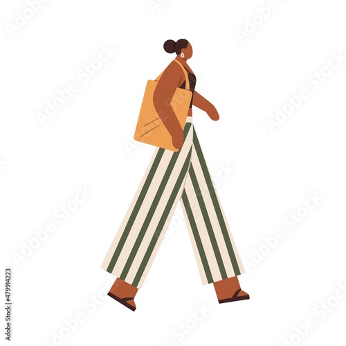 Black woman walking with tote bag. Modern female in casual clothes, pants, top and flip-flops, going. African-American person strolling. Flat vector illustration isolated on white background