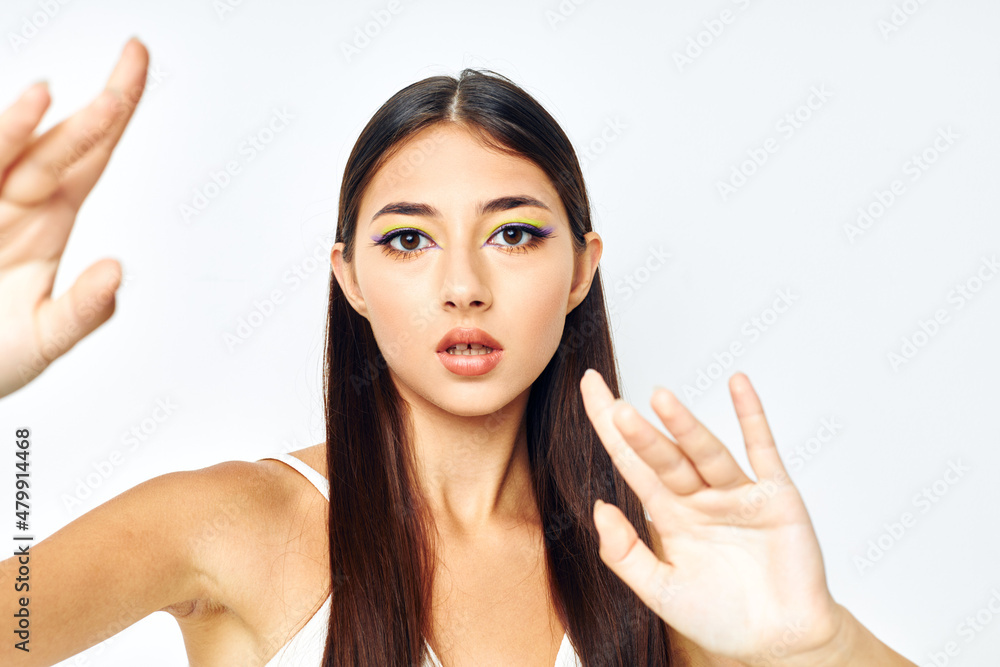 young woman white t shirt hand gestures charm isolated background unaltered young woman white t shirt hand gestures charm isolated background unaltered