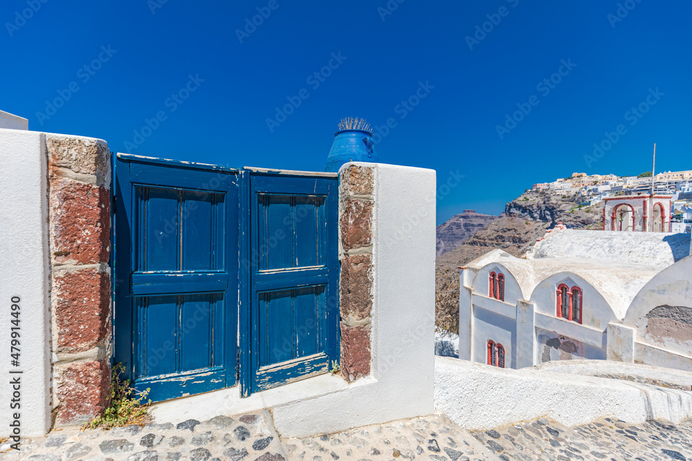 Fantastic travel background, Santorini urban landscape. Blue door or gate with stairs and white architecture under blue sky. Idyllic summer vacation holiday concept. Wonderful summer luxury vibes