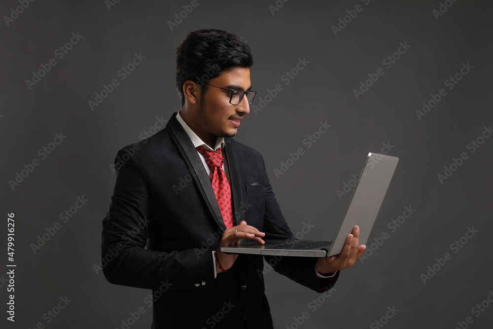 Young indian banker or officer using laptop Young indian banker or officer using laptop